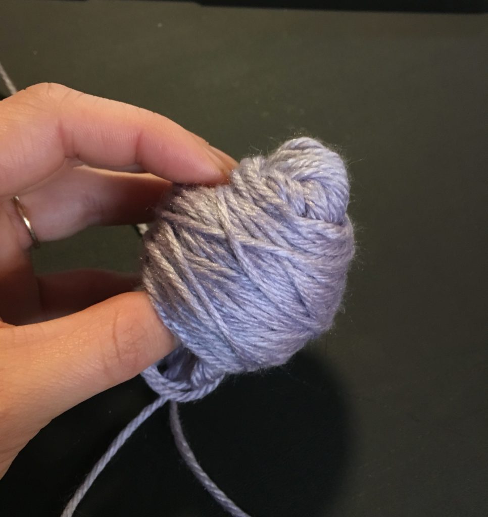 Step 3 for hand winding a ball of yarn