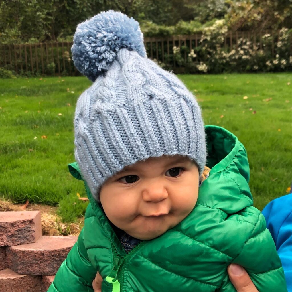 Fynn Wearing the Addy Hat By Knitting in the Park
