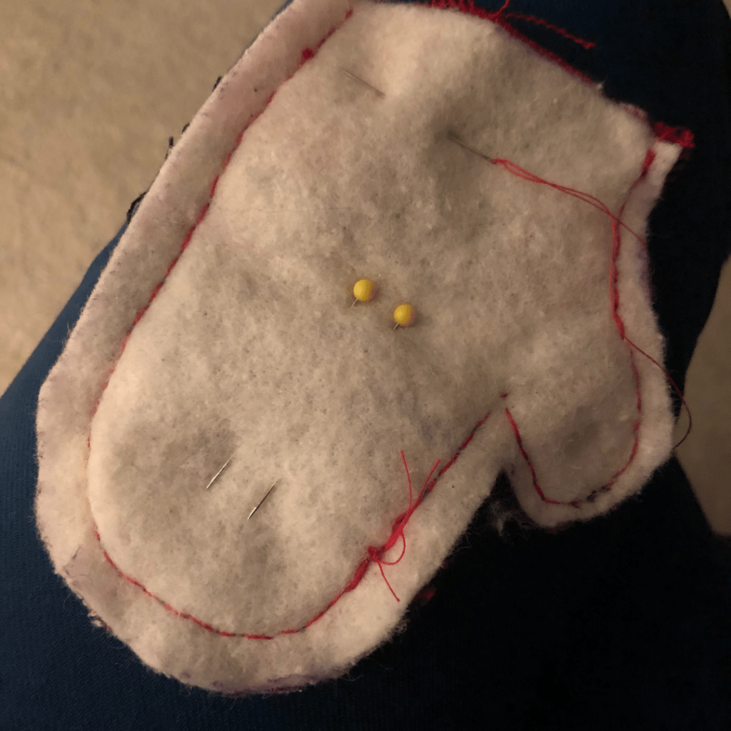 Sewing your mitten ornaments together