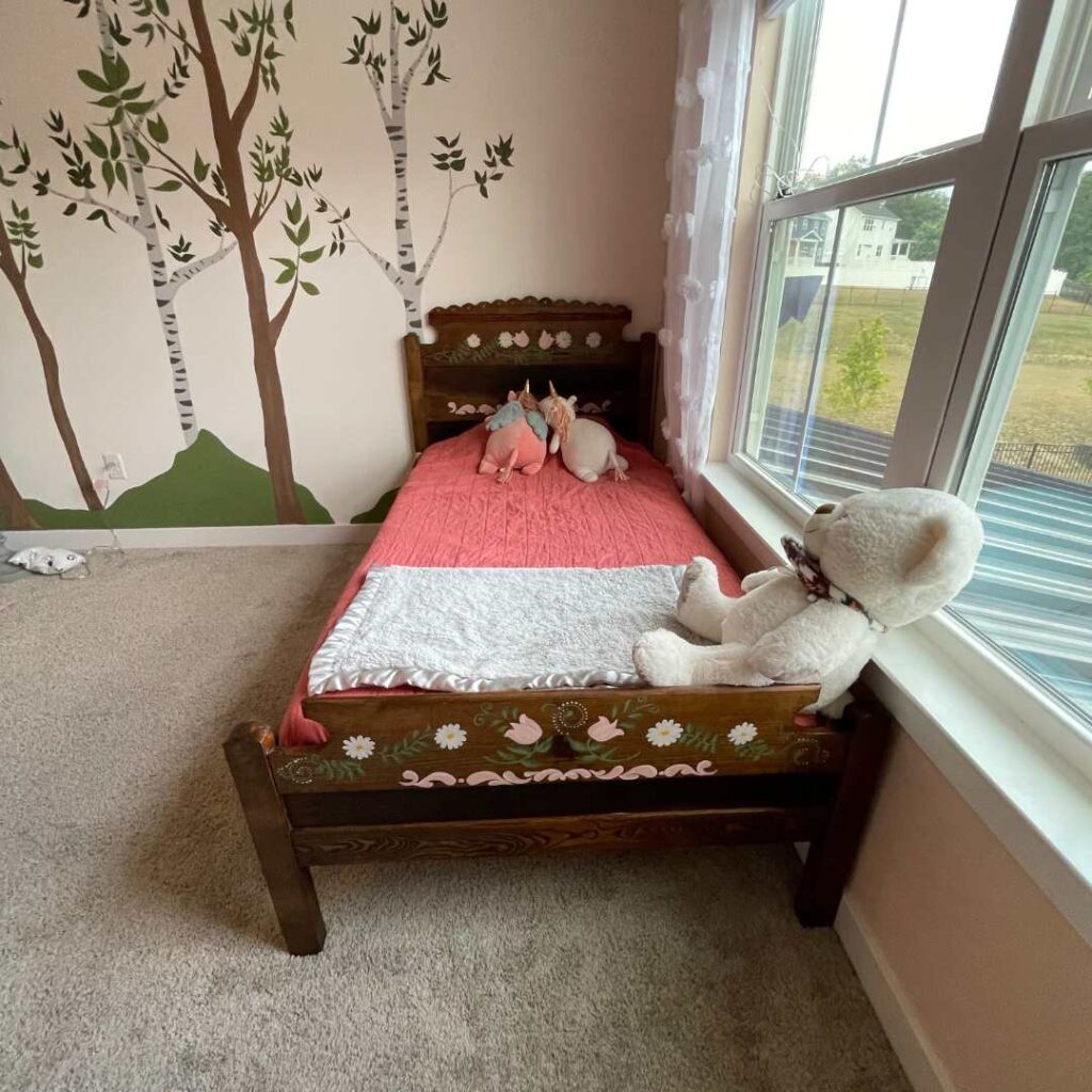 We combined tulips, daisies, and some pink detailing to complete the big girl bed frame