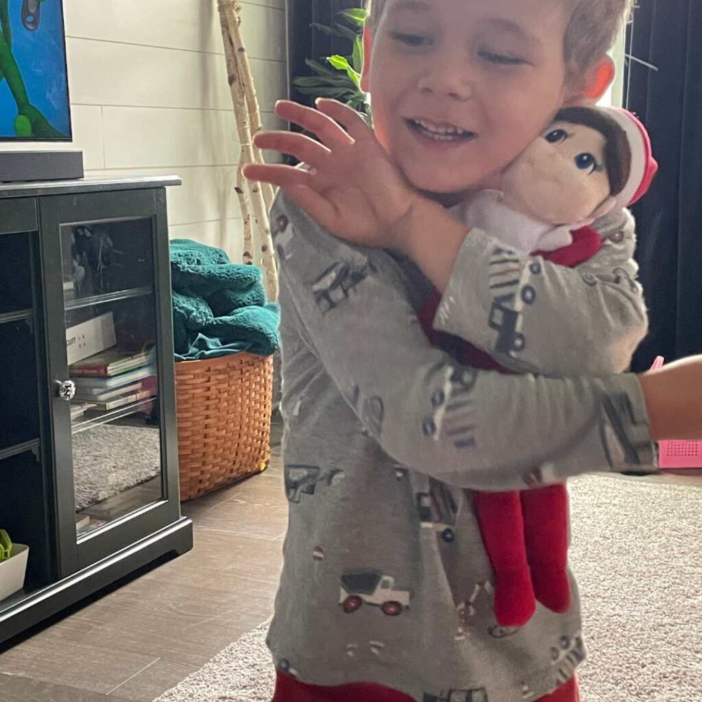 The magic of Christmas for little kids makes me want to start earlier and earlier every year. My four year old hugging his elf buddy.