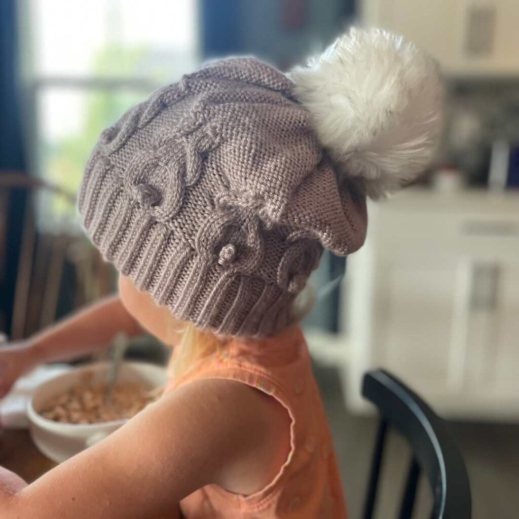 Nora's hat is a cute and fun knitting pattern that creates bunny cables as you knit.